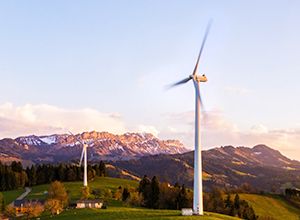 Windmills in the country side with a mountain at the background