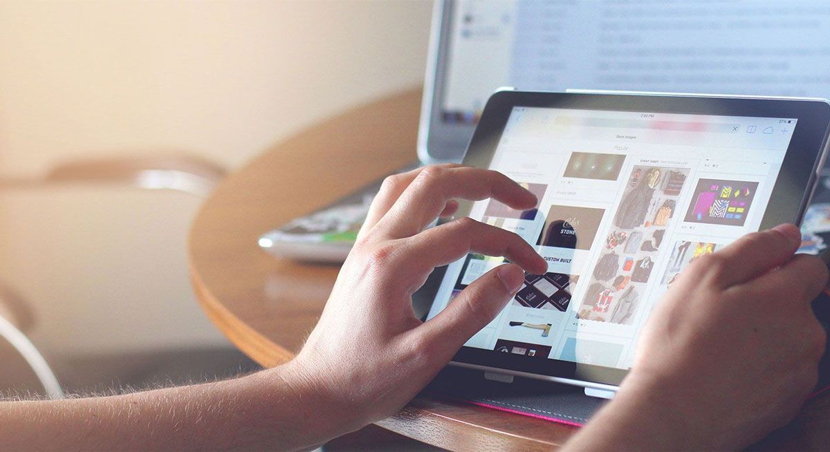 A person shopping online on a tablet
