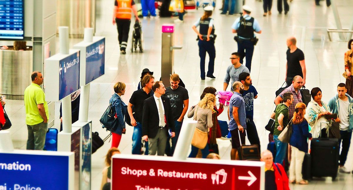 Passengers waiting to leave their luggage at the departure gate