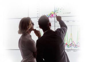 Two people discussing a graphic