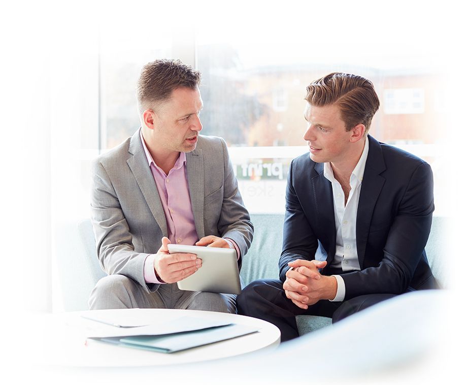 Two men discussing with an iPad