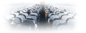 Plane seats with people from the back of a plane